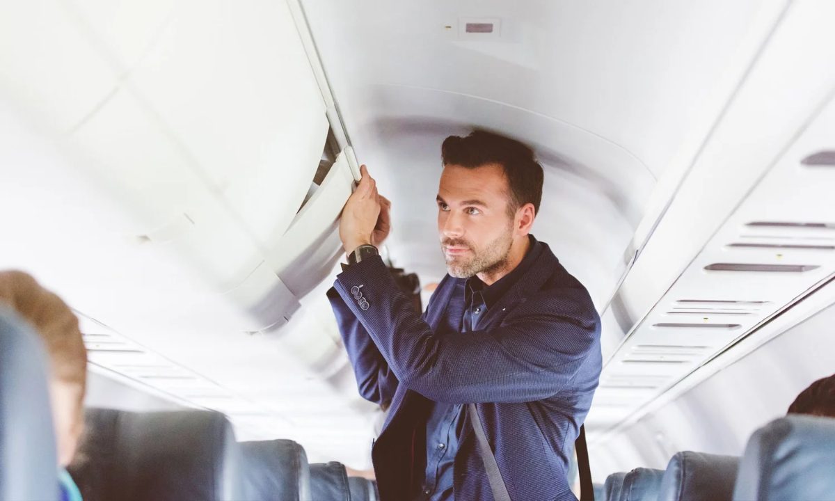 Passenger using an overhead composite locker